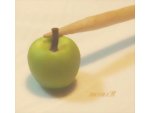 Inserting the stem into the miniature apple