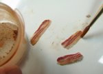 Using chalk pastel to color and highlight the miniature bacon