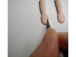 Showing where to cut to make the thumb of the dolls hand